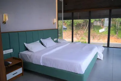 a large bed with white sheets and pillows in a bedroom at Velora Hotel And Resorts in Devāla