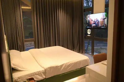 a hotel room with a bed and a television at Velora Hotel And Resorts in Devāla