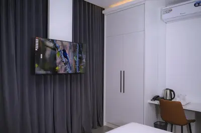 a room with a tv hanging on a curtain at Velora Hotel And Resorts in Devāla