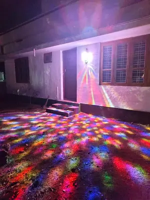 a room with a colorful light projected on the floor at SoNish Homestay Marayur - 3 bedroom for 25-30 people - Booking will be confirmed only after advance payment in Marayoor