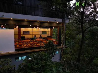 a building with a bunch of tables and chairs at Nvoyages Wayanad in Wayanad