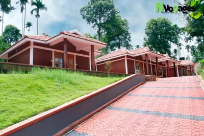 a house with a red brick walkway in front of it at Nvoyages Wayanad in Wayanad
