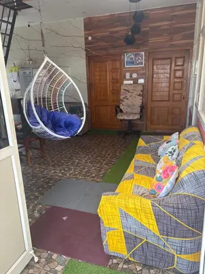 a room with a couch and a hanging bed at 4 Beds 6 People stay Calm, Comfortable Place in Mysore