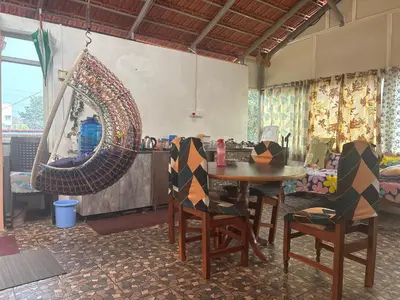 a room with a table and chairs and a mirror at 4 Beds 6 People stay Calm, Comfortable Place in Mysore