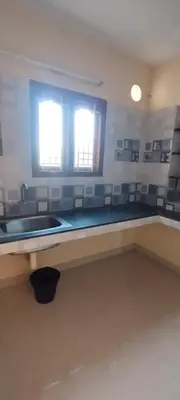 a kitchen with a sink and a window at Yakuhomestay in Vālpārai