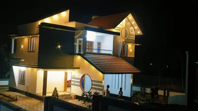 a house with people standing outside of it at night at Anjali Holiday Home in Tindummal