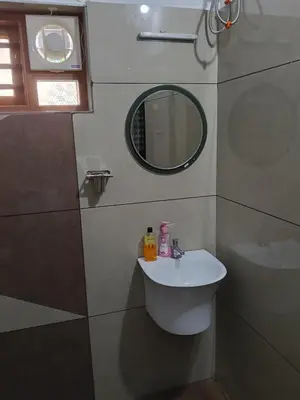 a bathroom with a sink and a mirror at Anjali Holiday Home in Tindummal