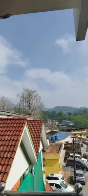 a view of a city with cars parked in a parking lot at sarathihomestay in Vālpārai