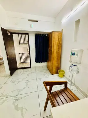 a room with a room with a door and a table at MIRACLE INN Rajagiri in Cochin