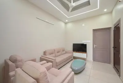 a living room with a couch and a tv at 4-Bedroom Villa near CIAL Airport 25 Min Drive ! in Alwaye