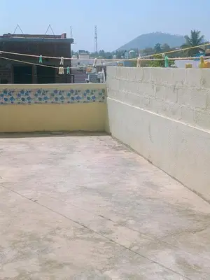 a concrete retaining wall next to a wall at Affordable home stay in Chāmrājnagar