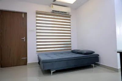 a bedroom with a bed in a room with a window at Vaiga Heavens , 1 BHK Apartment in Guruvāyūr
