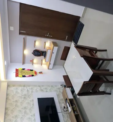 an overhead view of a room with stairs and a mirror at Vaiga Heavens , 1 BHK Apartment in Guruvāyūr