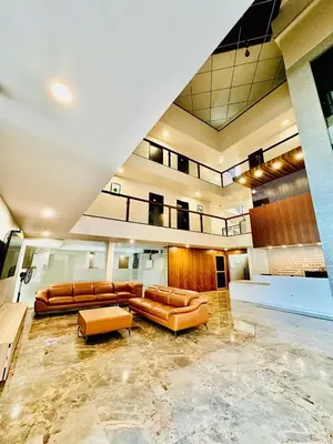 a lobby with couches and chairs in a building at IGNIVA Airport Hotel in Calicut