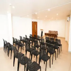 a room with a bunch of chairs and a table at IGNIVA Airport Hotel in Calicut
