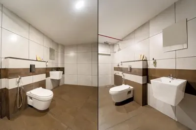 a bathroom with two toilets and a sink at IGNIVA Airport Hotel in Calicut