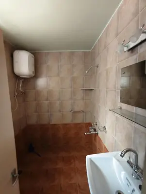 a bathroom with a shower and a sink at Grays club guest House in Coonoor