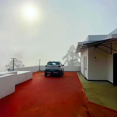 a car parked on top of a red carpet at Prysm Homestay - Kotagiri in Kotagiri