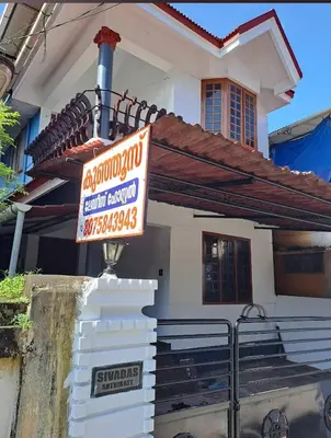 a sign in front of a house at Kunjoose Ladies Hostel in Trichūr