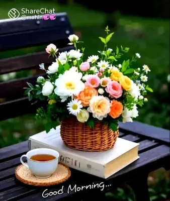 a basket of flowers and a cup of coffee on a book at Paarpidam in Tānūr