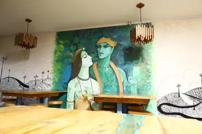a mural of a man and a woman in a restaurant at Valparai home villas in Vālpārai