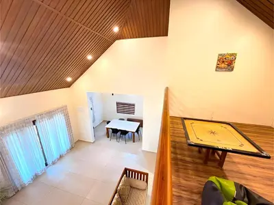 a room with a ping pong table and a dining room at Evara Stays Coorg in Kushālnagar