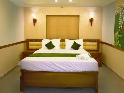 a bedroom with a bed with two towels on it at Amara Lux Rivage wynad in Vythiri