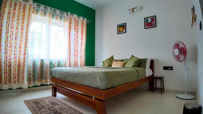 a bedroom with a bed and a window at Amariyah House -Luxury Villa in Coonoor in Coonoor