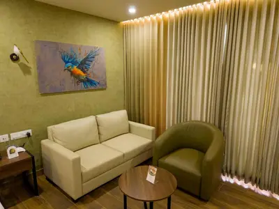 a living room with a couch and a chair at River Bay Athirappilly in Athirappilly