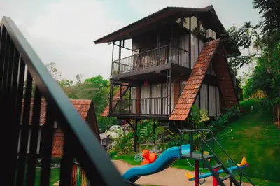 a house with a playground in front of it at Wood Panda Luxury Resort Wayanad in Meppādi