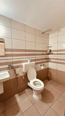 a bathroom with a toilet and a sink at Snehanilayam-1 in Trichūr