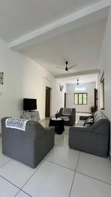 a living room with two couches and a tv at Snehanilayam-1 in Trichūr