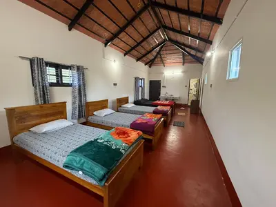 a bedroom with three beds in a room at Blue chill villa in Madikeri