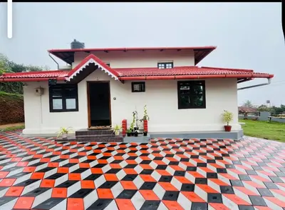 a house with a checkered floor in front of it at Blue chill villa in Madikeri