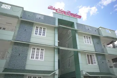 a building with a red sign on top of it at Blue Vista Residency in Kalpetta