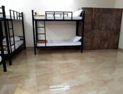 a room with two bunk beds and a wooden floor at cozstel in Kozhikode