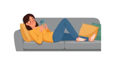 a woman sitting on a couch holding a cell phone at cozstel in Kozhikode