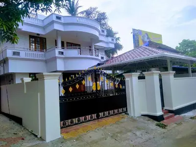 a white house with a gazebo in front of it at Gayathri in Trichūr