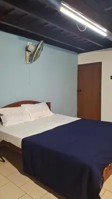 a bedroom with a bed with a blue comforter at Heritage tharavadu in Mananthavady