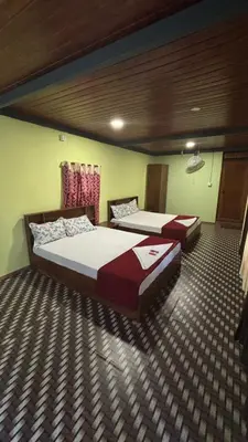two beds are in a room with at Heritage tharavadu in Mananthavady