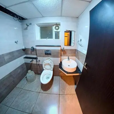a bathroom with a toilet and a sink at krishna suites guruvayur in Guruvāyūr