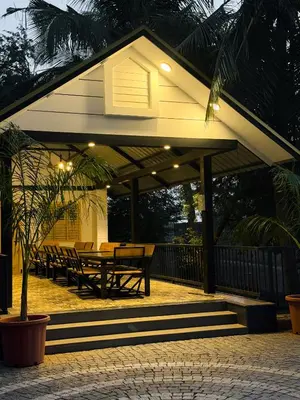 a pavilion with a table and benches on a patio at SRK luxe resort