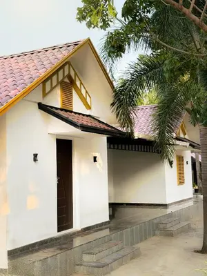 a white house with a red roof at SRK luxe resort