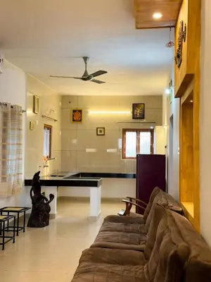 a living room with a couch and a pool table at SRK luxe resort