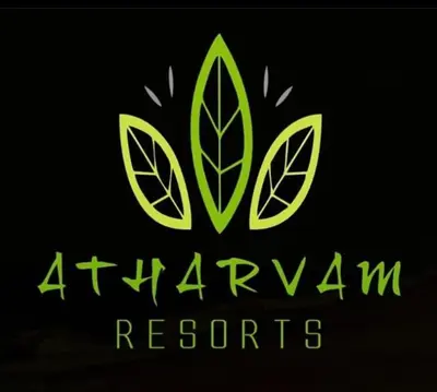 a green logo for a company with leaves on it at Atharvam Resort in Cherai Beach