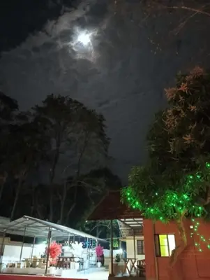 a full moon over a restaurant at night at The Multi Gen Retreat at gaya3farms in Parli
