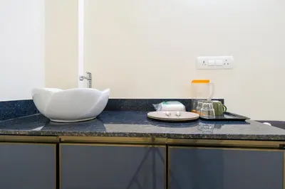 a bathroom counter with a sink on a counter top at Hotel Aeronest Residency in Calicut
