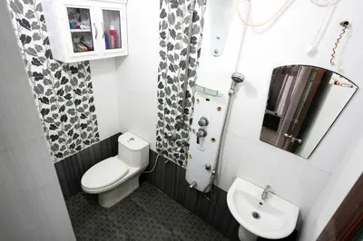 a small bathroom with a toilet and a sink at Guruvayur Nature Homestay in Kunnamkulam