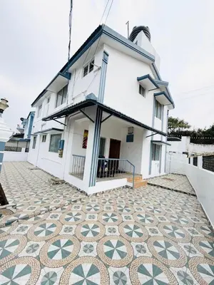 a building with a mosaic floor in front of it at Majestry Cottage in Ooty