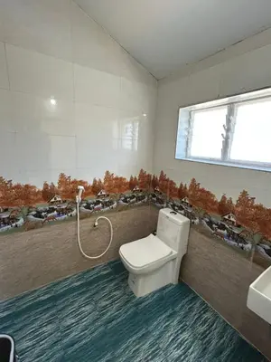 a bathroom with a toilet and a sink at Majestry Cottage in Ooty